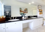 Thumbnail 6 of 26 - Spacious master bathroom with granite countertops, double sink vanity, double mirror vanity, at Tuscany Villas Apartments in Houston, Texas