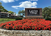Thumbnail 1 of 43 - the sign apartments in front of red flowers