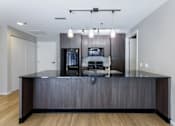 Thumbnail 37 of 41 - A modern kitchen with a dark wood finish.