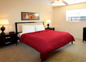 Thumbnail 15 of 19 - Spacious bedroom with ceiling fan and walk-in closet at Plantation apartments near the Galleria in Houston.