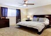 Thumbnail 3 of 19 - Spacious bedroom with ceiling fan and walk-in closet at Plantation apartments near the Galleria in Houston.