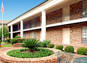Thumbnail 12 of 19 - Apartments near the Galleria with brick exteriors, beautiful landscaping and courtyard setting at Plantation apartments in Houston.