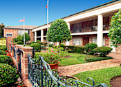 Thumbnail 7 of 19 - Apartments near the Galleria with brick exteriors, beautiful landscaping and courtyard setting at Plantation apartments in Houston.
