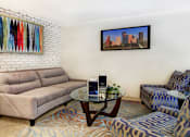 Thumbnail 8 of 19 - Spacious living room with white brick feature wall at Plantation apartments near the Galleria in Houston.