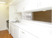 Thumbnail 13 of 19 - Apartments near the Galleria with bright white kitchens, wood plank floors, and extra cabinet space