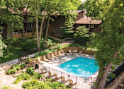 Thumbnail 26 of 43 - a backyard with a swimming pool and a house with trees