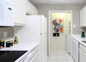 Thumbnail 13 of 30 - Bright white kitchen, spacious kitchen and full size and washer and dryer at Preston Village Apartments in North Dallas