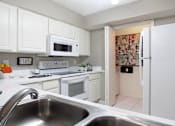 Thumbnail 18 of 30 - Bright white kitchen, spacious kitchen and full size and washer and dryer at Preston Village Apartments in North Dallas