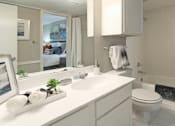 Thumbnail 21 of 30 - Spacious bathroom with white cabinets and white porcelain tile at Preston Village Apartments in North Dallas