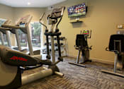 Thumbnail 19 of 30 - Luxury apartments with a fitness center in a gated community at Preston Village Apartments in North Dallas