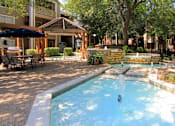 Thumbnail 20 of 30 - Luxury apartments with beautiful fountains, beautiful landscaping, gazebo, spa and swimming pool with poolside lounge chairs, grilling station and scenic views at Preston Village Apartments in north Dallas