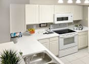 Thumbnail 28 of 30 - Bright white kitchen, spacious kitchen and full size and washer and dryer at Preston Village Apartments in North Dallas