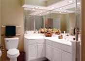 Thumbnail 21 of 26 - Luxury apartments with oval soaking tub, separate glass shower, built-in vanity, and cultured marble vanity top at RidgeGate Apartments in Minnetonka, Minnesota
