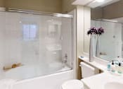Thumbnail 18 of 20 - Luxury apartments with spacious bathrooms with glass showers, oval soaking tubs, and cultured marble vanities at Tuscany Gate Apartments in Houston.