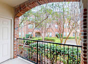 Thumbnail 28 of 73 - Gated luxury apartment community in north Dallas with red brick exteriors, large patio, and beautiful landscaping at The Saxony Apartments