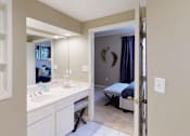 Thumbnail 42 of 73 - Luxury apartments with spacious bathrooms with tiled floors, linen closet, oval soaking tubs, built-in vanity, cultured marble vanity, glass shower and white cabinets in at The Saxony Apartments