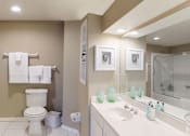 Thumbnail 6 of 20 - Luxury apartments with spacious bathrooms with glass showers, oval soaking tubs, built-in shelves, spacious linen closets, and cultured marble vanities at Tuscany Gate Apartments in Houston.