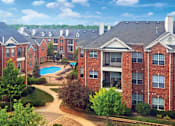 Thumbnail 30 of 38 - Luxury apartments with red brick exteriors, spacious balcony, and lush landscaping at TurtleCreek apartments in West Des Moines, Iowa