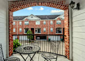 Thumbnail 8 of 34 - Luxury townhomes in a gated community with red brick exteriors and attached 2-car garages at Tuscany Row Townhomes in Houston.