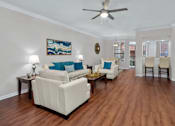 Thumbnail 26 of 26 - Spacious living room, huge living room with wood-burning fireplace, hardwood floors, crown molding, breakfast bar, spacious dining room, and 9-foot ceilings, at Tuscany Villas in Houston.