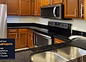 Thumbnail 4 of 36 - Spacious kitchen with granite countertops, stainless steel appliances and custom home cabinetry.