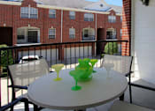 Thumbnail 19 of 26 - Luxury townhomes in a gated community with red brick exteriors and attached 2-car garages at Tuscany Villas in Houston.