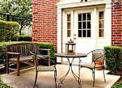 Thumbnail 13 of 26 - Private backyard patios and red brick exteriors at Tuscany Villas in Houston.
