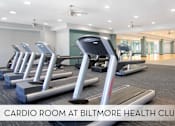 Thumbnail 19 of 36 - A cardio room at Biltmore Health Club with treadmills and elliptical machines.