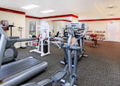Thumbnail 8 of 30 - Fitness center with fitness equipment, cardio equipment, and weights at the Vanderbilt Apartments in Omaha, Nebraska