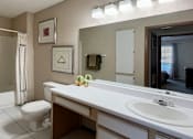 Thumbnail 26 of 44 - Spacious bathroom with tiled floor, tiled shower with bathtub, extra cabinet space and linen closet at Tanglewood Apartments in Lincoln Nebraska