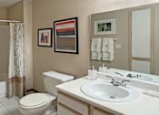 Thumbnail 14 of 44 - Spacious bathroom with tiled floor, tiled shower with bathtub, extra cabinet space and linen closet at Tanglewood Apartments in Lincoln Nebraska
