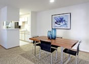 Thumbnail 15 of 44 - Spacious dining room area and kitchen with tiled floor, white cabinets, and lots of cabinet space at Tanglewood Apartments in Lincoln Nebraska