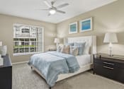 Thumbnail 16 of 40 - Spacious master bedroom with attached master bathroom, spacious walk-in closet and grey colored walls at Village on the Parkway Apartments in Houston, Texas
