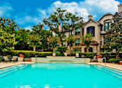 Thumbnail 38 of 40 - Luxury swimming pool with poolside lounges, 2 resort-style swimming pools with spa, beautiful landscaping, lush landscaping at Village on the Parkway Apartments.