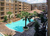 Thumbnail 33 of 36 - Luxury apartments with palm trees, spa, hot tub, spacious sundeck with poolside lounge chairs, beautiful landscaping, and fountains at Villa Piana Apartments in Dallas