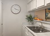 Thumbnail 11 of 22 - Bright white kitchens with wood plank floors at Waters of Winrock Apartments in Houston