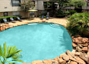 Thumbnail 9 of 22 - Gated apartment community close to the Galleria with pool, spa, poolside lounge chairs, lush landscaping, beautiful landscaping, and neighborhood setting.