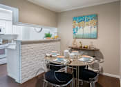 Thumbnail 13 of 22 - Spacious one and two bedroom floor plans with white brick accent walls and wood plank floors at Waters of Winrock Apartments in Houston