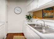 Thumbnail 4 of 22 - Bright white kitchens with wood plank floors at Waters of Winrock Apartments in Houston