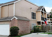Thumbnail 38 of 38 - Gated apartment community in the Bayou area of Houston with attached garages, covered parking, 2 swimming pools, lush landscaping, and scenic views at Woodlake Oaks Apartments in Houston.