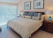 Thumbnail 34 of 42 - Huge master bedroom with vaulted ceiling, built-in shelves, attached master bathroom and walk-in closet at Woodlake on the Bayou Apartments in Houston.