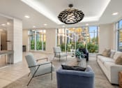 Thumbnail 6 of 8 - A modern living room with a large window and a view of the outdoors.