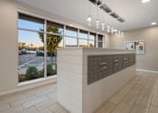 Thumbnail 1 of 8 - A reception area with a large window overlooking a parking lot.