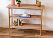 Thumbnail 5 of 6 - A wooden shelf with a plant and a vase on it.