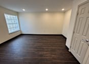 Thumbnail 4 of 14 - A room with a white door and a window with blinds.