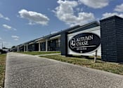 Thumbnail 1 of 14 - A sign for Autumn Chase stands in front of a building.