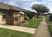 Thumbnail 8 of 8 - A residential street with a house on the left and a sidewalk.