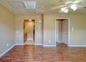 Thumbnail 4 of 8 - A room with wooden floors and a ceiling fan.