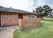 Thumbnail 6 of 8 - A house with a red door and a brown fence.