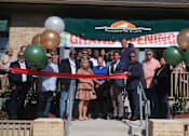 Thumbnail 1 of 3 - A group of people are gathered for a ribbon cutting ceremony.